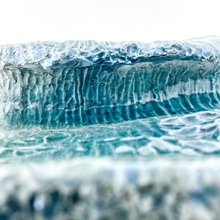 Wave in glazed ceramic. Sculpture created by Jaime Carvalho. Currently in the exhibition at Galeria Resistência in Lisbon. Inspired by the sea and wanting to represent its beauty and strength, Jaime developed a series of works in different materials, such as marble, wood, and metal, representing waves and the sea.